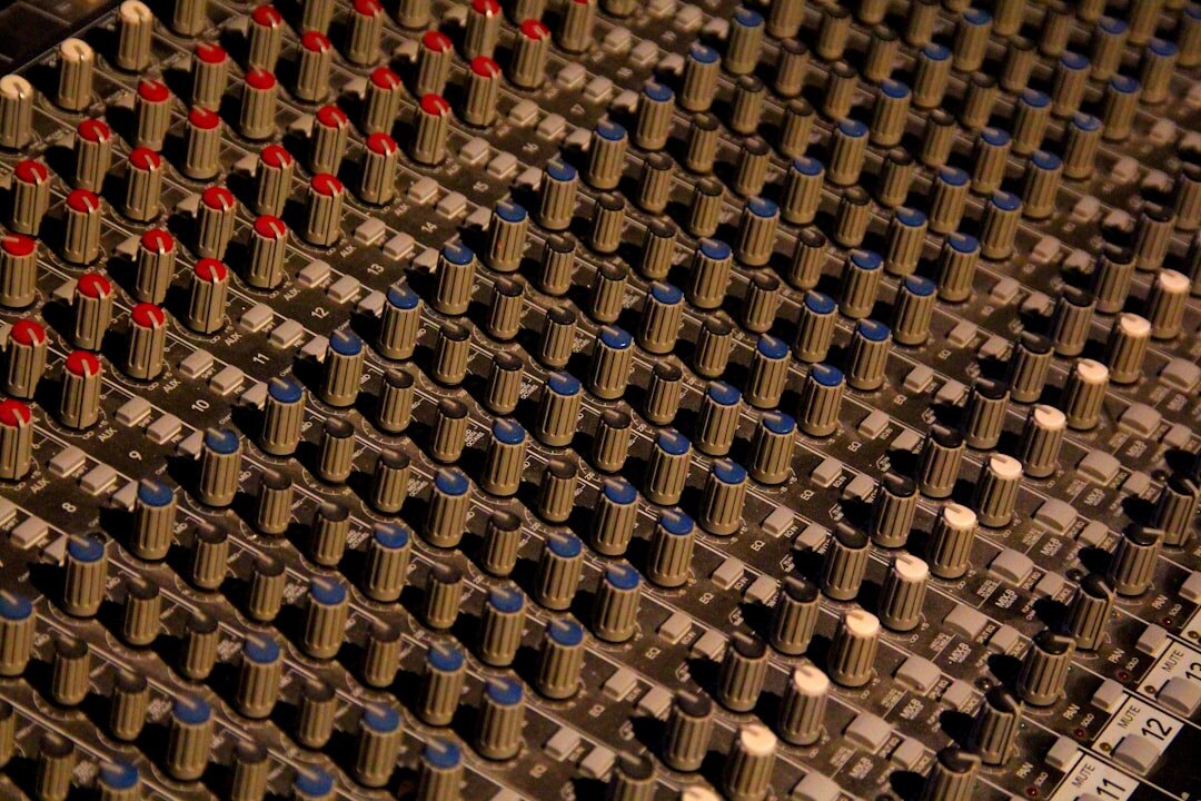 Broadcast audio mixing console with sliders and meters